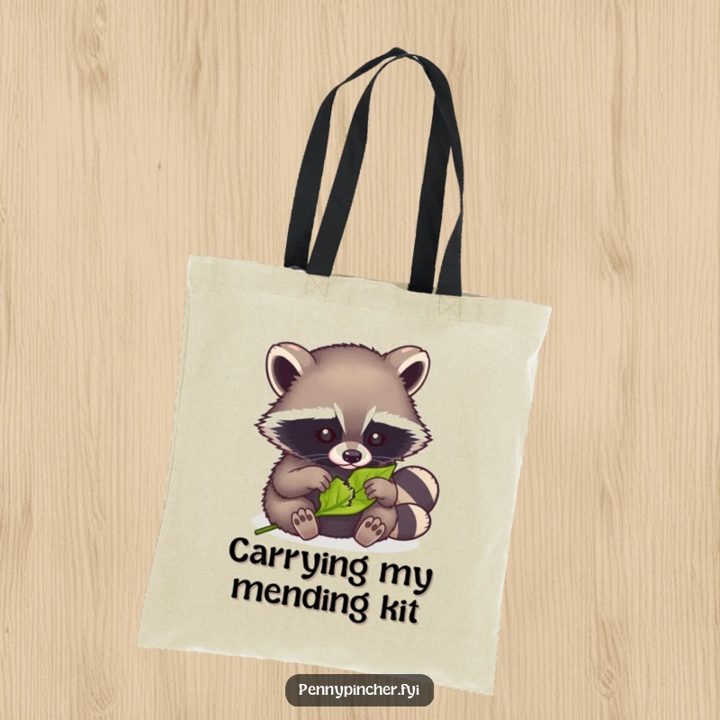 Funny tote bag with a clever raccoon carefully mending a tiny torn leaf, ideal for daily use.